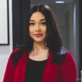 Nicole smiling wearing red shirt standing in law office