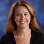 Christine smiling wearing black long sleeve shirt