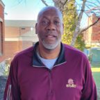 David smiling outside wearing athletics STAC maroon sweatshirt