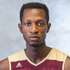 Kwabena posing for photo with gray background