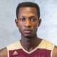 Kwabena posing for photo with gray background