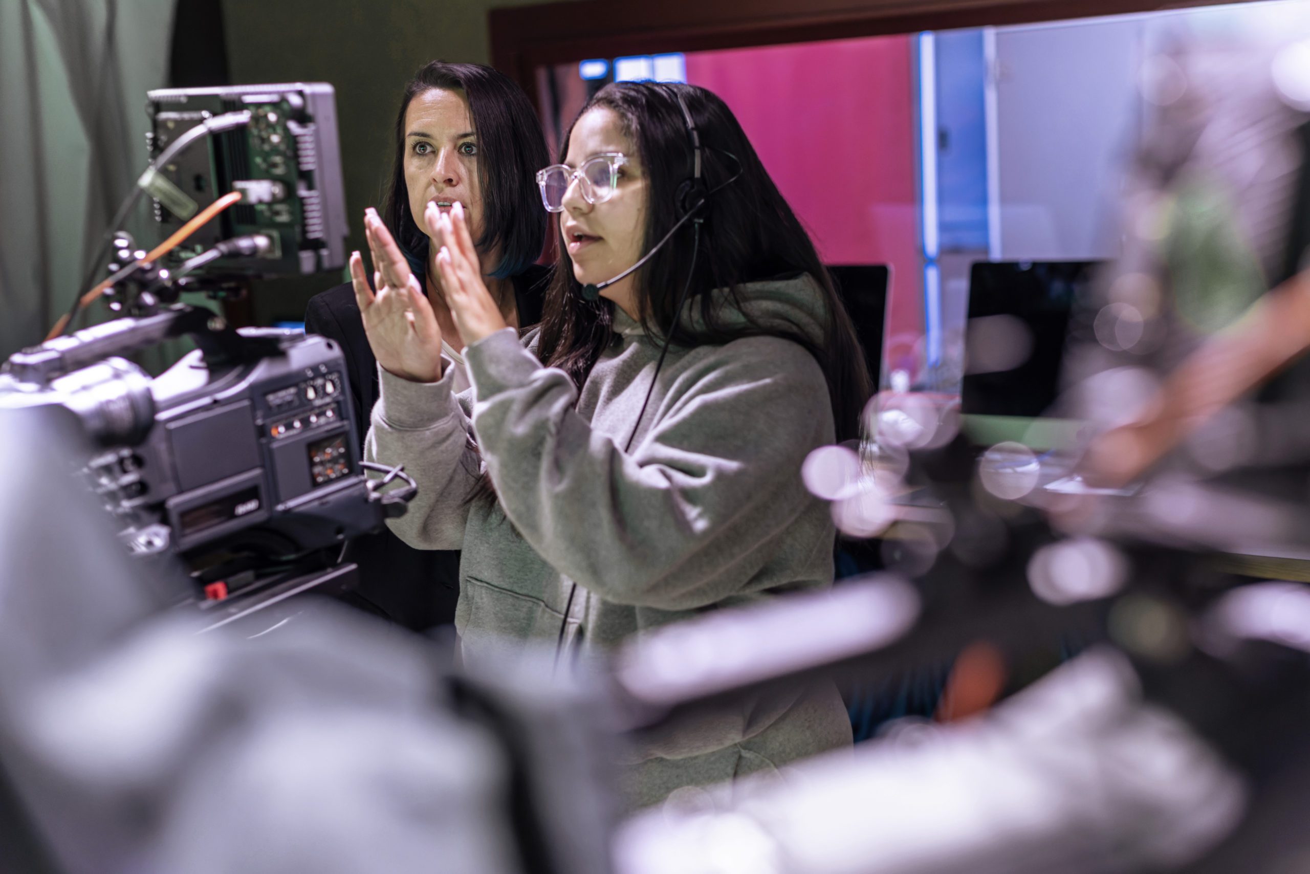 A female student and her professor working with a in the studio.