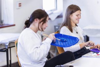Two students working on clay models on an Art Therapy class