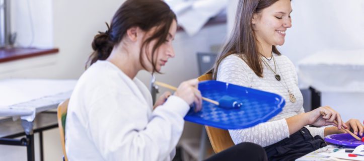 Two students working on clay models on an Art Therapy class