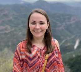 Student on top of a mountain