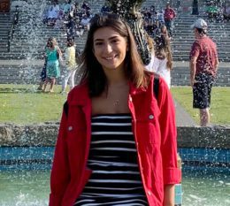 Student in front of a fountain