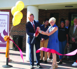 Ken and Rose cutting ribbon with RSAC and students in the background