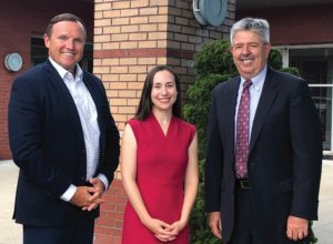 President Daly, Dean Bianca Wentzell and Bill Madden in front of Aquinas Hall