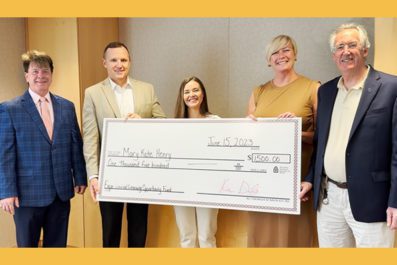 Mary Kate posing with large check alongside STAC President Ken Daly, VP Flood, Prof McDonnell and Dean Murphy smiling