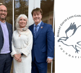 Dean Bowen, Kathryn from the Foundation, and Thomas Flood standing together outside smiling wearing suit jackets and dress