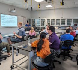 Professors in STEM lab classroom working on group projects during Academy