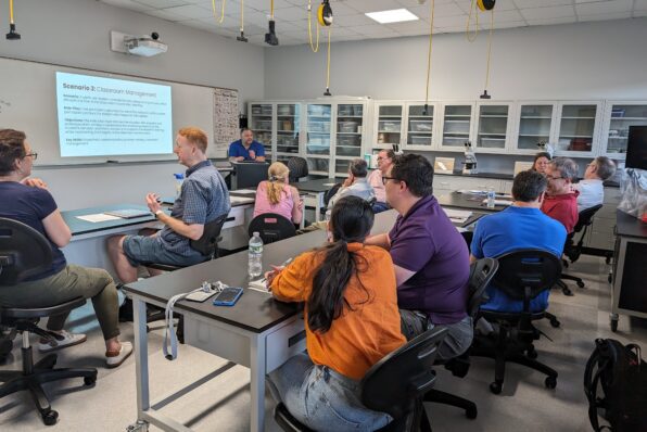 Professors in STEM lab classroom working on group projects during Academy