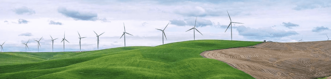 Drawing of wind turbines on a green and brown landscape