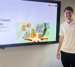 Nicholas smiling with presentation in background