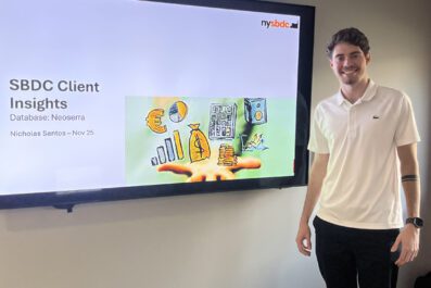 Nicholas smiling with presentation in background