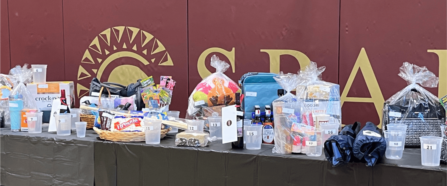Silent auction items on a long table.