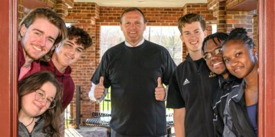 Ken Daly surrounded by students