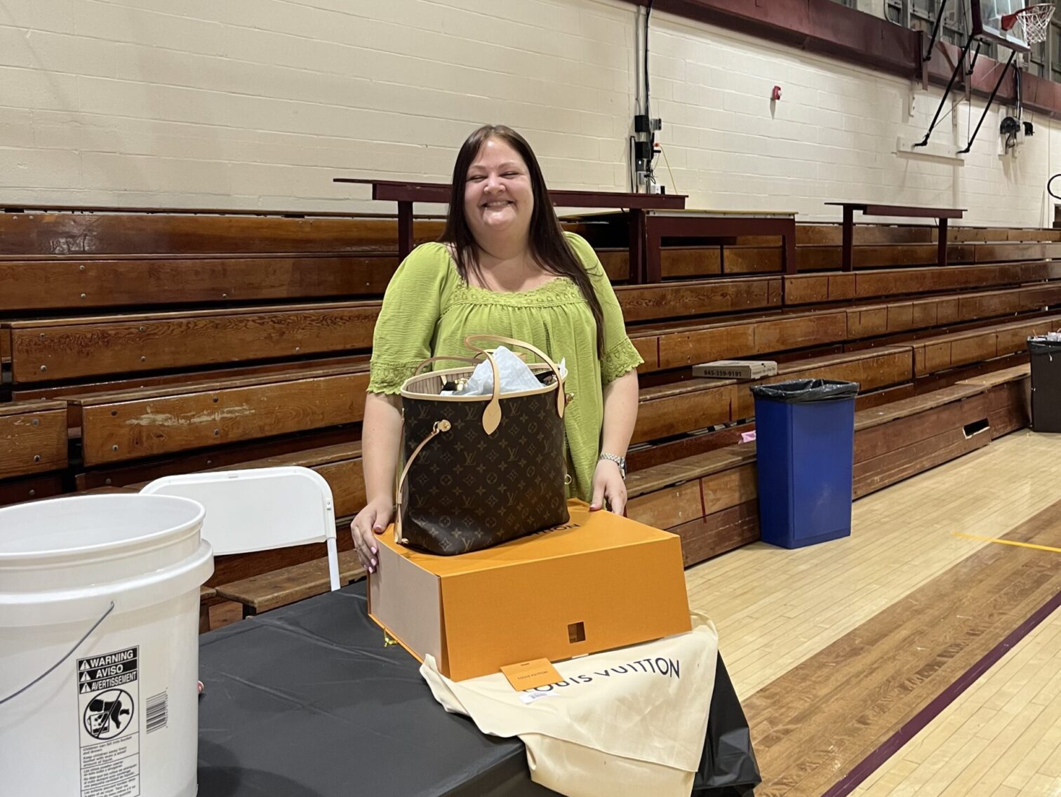 Winner of the Louis Vuitton raffle with her prize.