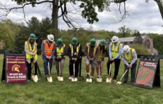 track groundbreaking with 8 individuals from LandTek, the Town, and College administration and students shoveling into the ground wearing hard hats and vests