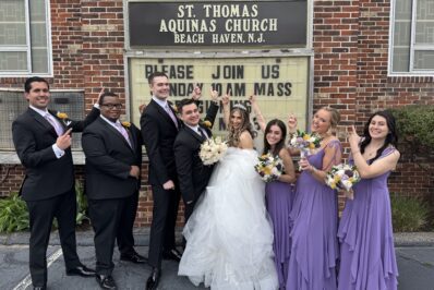 DeCarlo wedding party standing in front of church